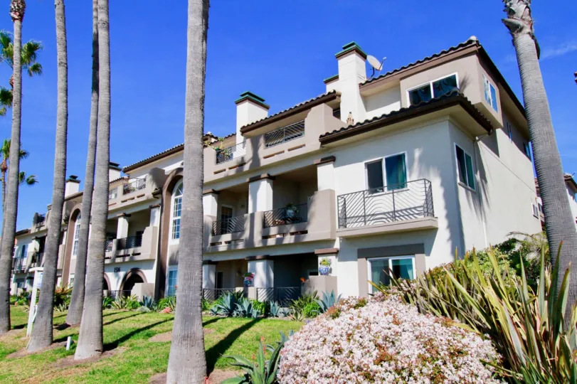 THE BUILDING WITH TWO FLOORS AND THE TOP ROOF BALCONY ALSO AVAILABLE AND MORE TREES IN FRONT OF THE HOUSE.