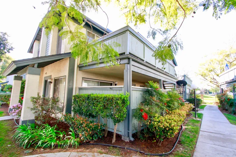 THE HOUSE WITH A NUMBER SIGN AND A BEAUTIFUL GARDEN IN FRONT OF THE HOUSE A PATH ALSO NEAR TO THE PLACE TO WALK