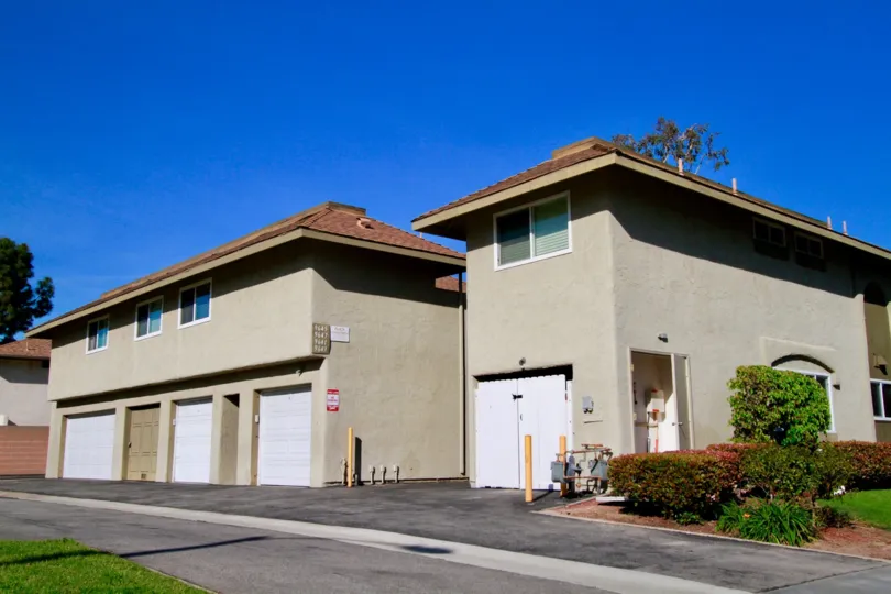 Yorktown Villas apartments with garages next to a street on a sunny day.