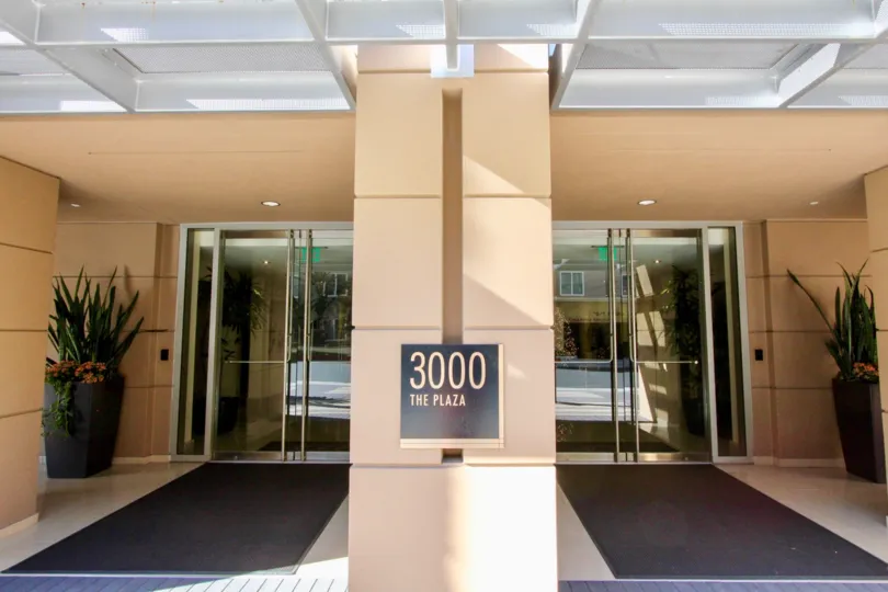 a pleasant day in the 3000 the plaza with a building that has glass door with a wall partition