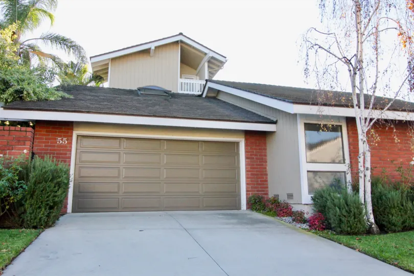 clean and clear area view in front garage near house having trees and plants around in Arborlake