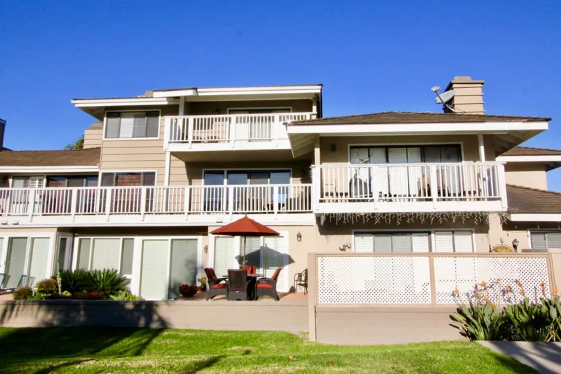 A large three story residential building with white railings at Arborlake in Irvine CA