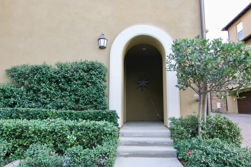 THE FRONT WAY TO THE HOME WITH MANY PLANTS ARE THERE WHICH IS LOCATED IN THE CITY OF IRVINE