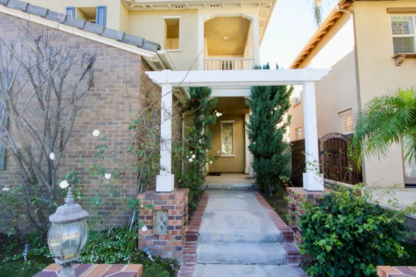 THE FRONT VIEW OF THE HOUSE WITH PLANTS, CORRIDOR WHICH IS IN BELLA ROSA COMMUNITY
