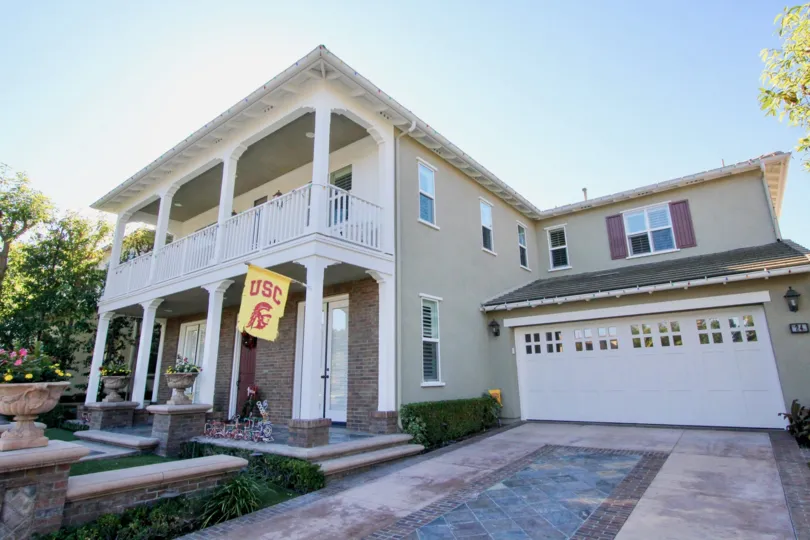 THE VILLAS IN THE BELLA ROSA WITH THE USC FLAG, FLOWER PLANTS, TREES, LAWN