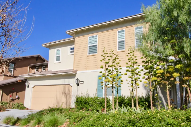 THE HOUSE WITH SHED NEARBY PLANTS AND TREES ARE IN THE BIRCH TRAIL COMMUNITY