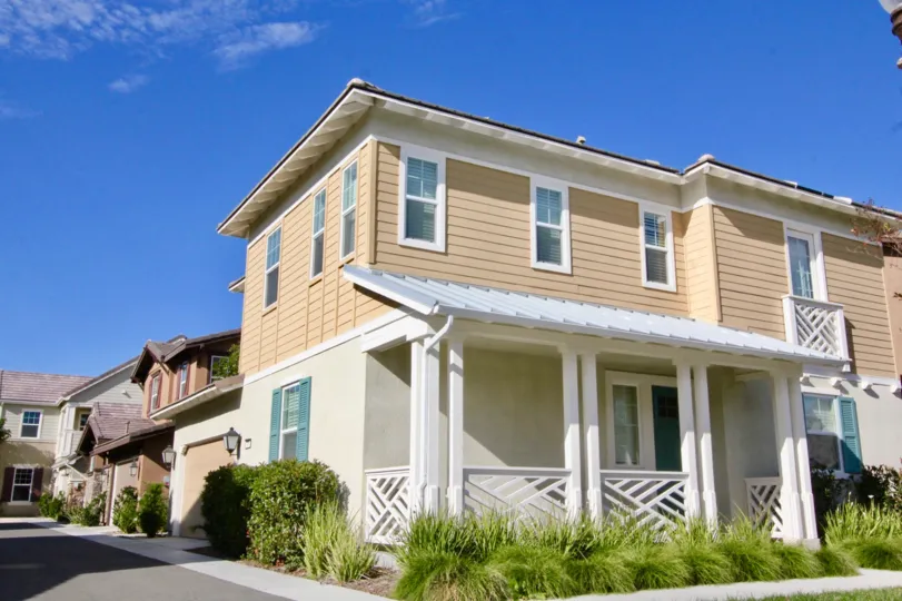 A sunny day in Birch Trail, with large houses and hedges