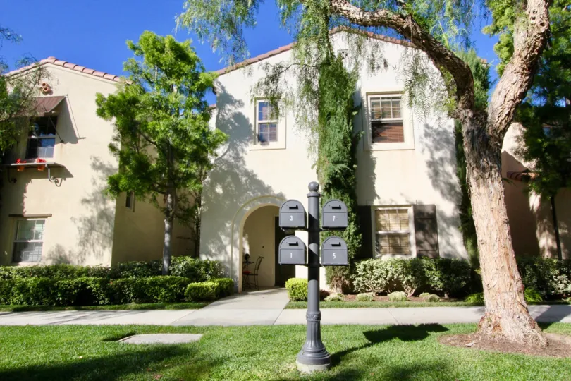 THE VILLA WITH LARGE TREES, PLANTS, LAWN ARE SHOWN IN THIS IMAGE WHICH IS IN IRVINE CITY