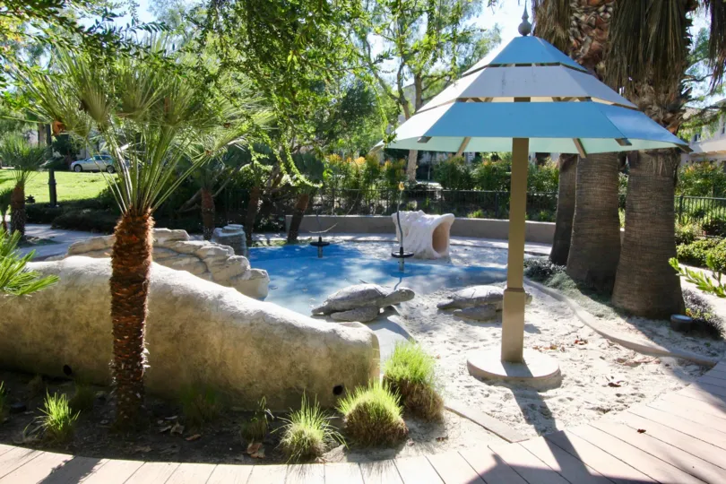 A kids play area with stone turtles and a large shell located at bowen court in irvine ca