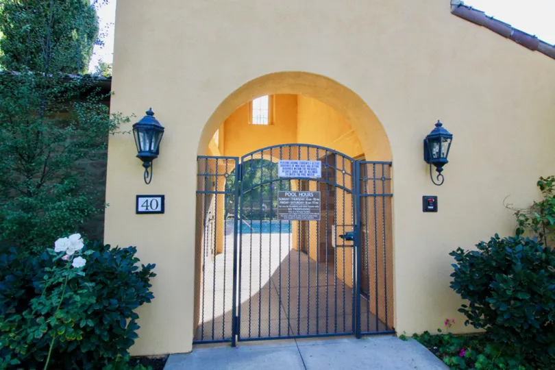The gated entrance to the pool at Canyon's Edge and surrounding landscaping