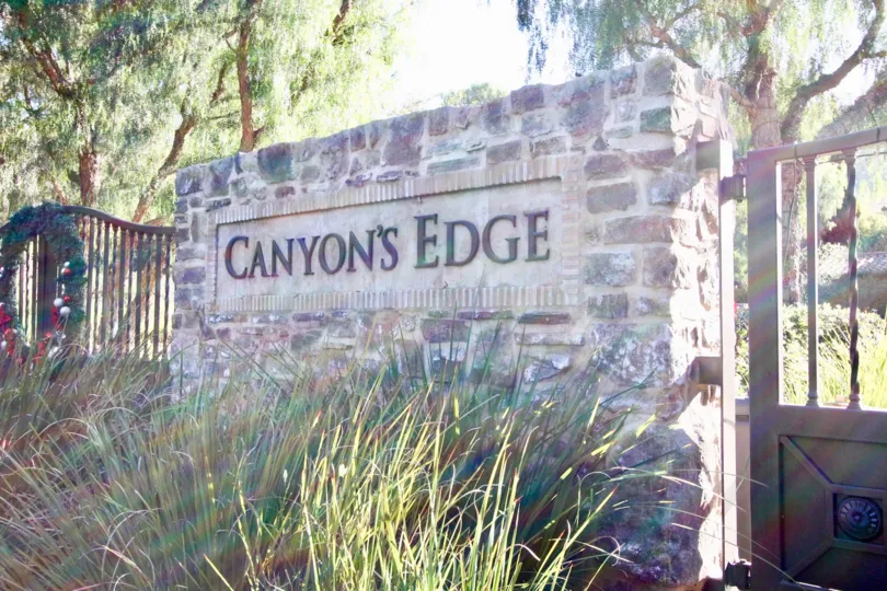 A community sign made of stone bricks outside Canyon's Edge in Irvine CA