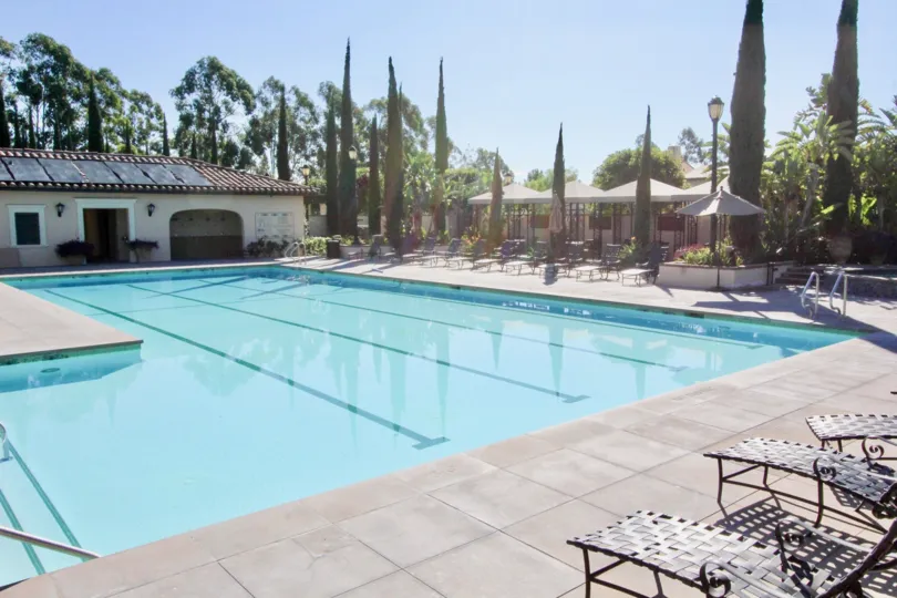An empty pool in Coronado community with empty seats.