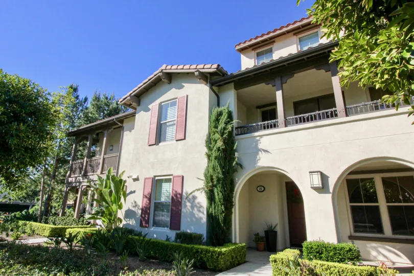 THE LARGE HOUSE WITH PLANTS, TREES IN THE FRONT WHICH IS LOCATED IN IRVINE CITY