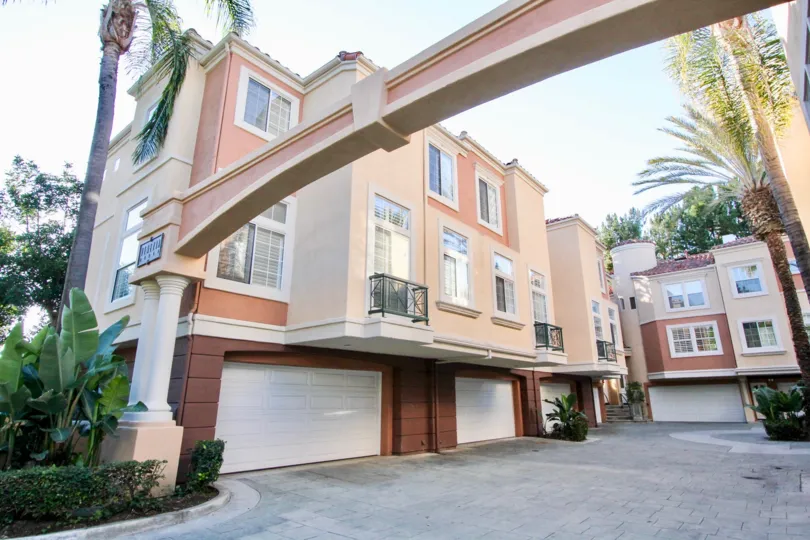 A large arch in front of the buildings in Corte Bella Villas