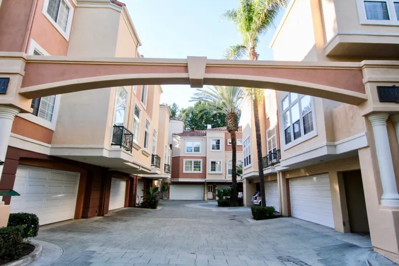 Come home to a palm tree lined path and your own private garage at Corte Bella Villas