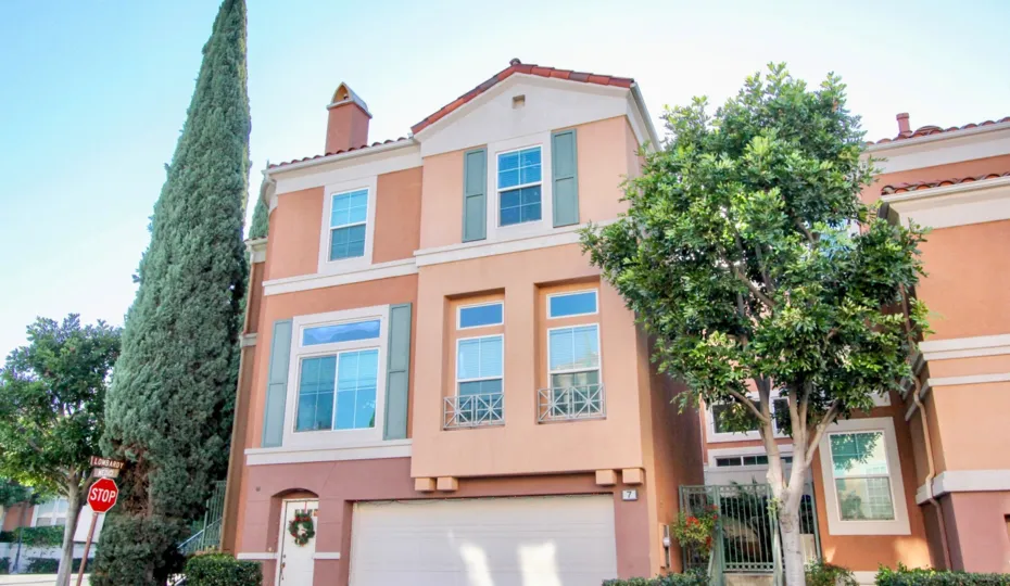 THE FRONT VIEW OF HOUSE WITH SHED, TREES, PLANTS, STOP BOARD ARE SHOWN IN THE CITY OF IRVINE