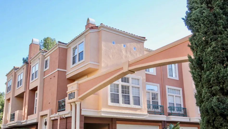 An apartment buildling with garages underneath and balconies in front of each window in the Corte Bella community in Irvine, California