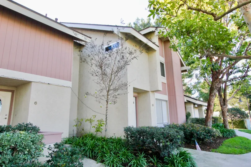 a warm day in the deerfield townhomes with building that has garden around glass windows