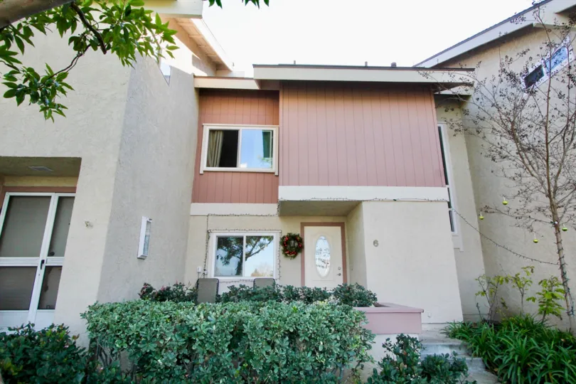 THE FRONT VIEW OF HOME WITH PLANTS AND TREES WHICH IS SITUATED IN IRVINE CITY