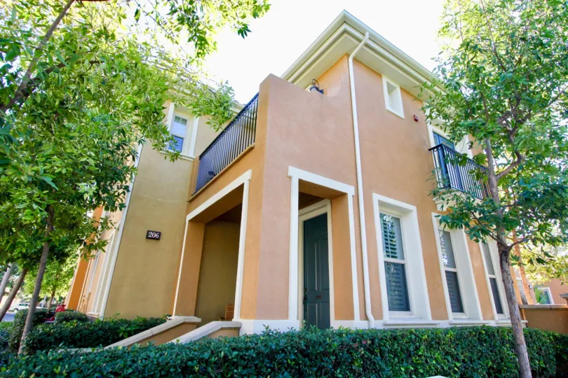 THE FRONT VIEW OF THE HOME WITH LOT OF TREES, PLANTS WHICH IS PLACED IN IRVINE