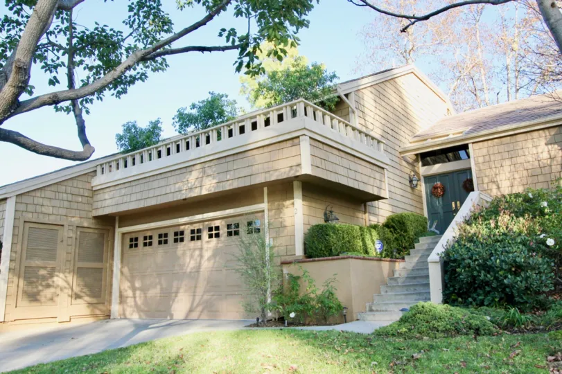 THE FRONT VIEW OF HOUSE WITH STEPS, NEARBY PLANTS, TREES WHICH IS LOCATED IN GLEN GARDEN HOMES