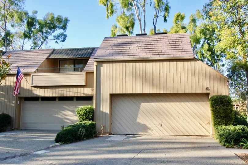 THE FRONT VIEW OF HOME WITH SHED, BACKSIDE LOT OF TREES, PLANTS ARE SHOWN IN THE CITY OF IRVINE