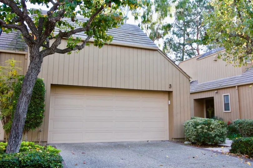 A garage and home seen from the driveway on a sunny day in Glen Townhomes