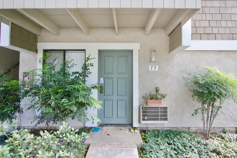 Door step view of the building having plants around in Irvine Springs