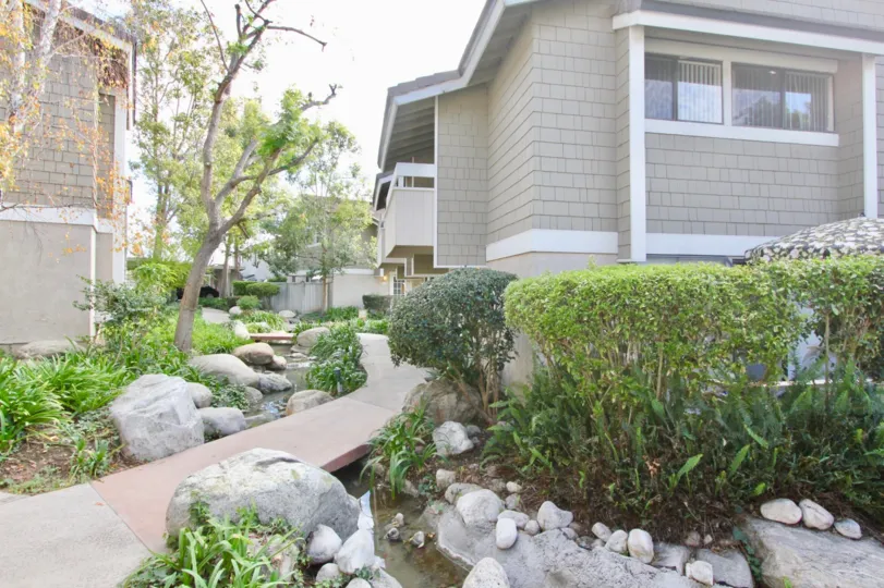 A house with massive entrance with gardens and big tress in Irvine Springs irvine, California