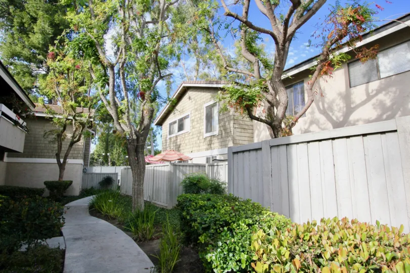 THE BACKSIDE VIEW OF THE VILLAS WHICH HAS LOT OF PLANTS, TREES WHICH IS IN IRVINE SPRINGS COMMUNITY