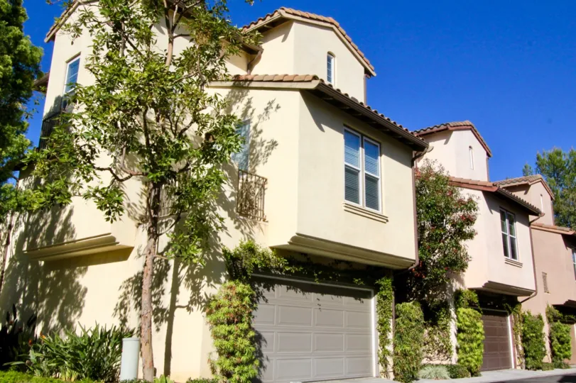 a warm day in the lvy wreath with a building that has 2 parking door closed and roofless top and garden in the front