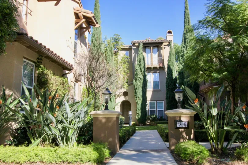 THE FRONT WAY TO VILLA WITH LOT OF PLANTS, TREES, LIGHT LAMPS ON EACH SIDE WHICH IS IN IRVINE CITY