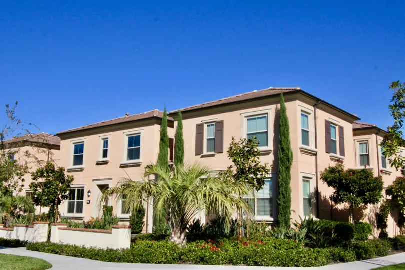 a sunny day in the jade court with building that has garden around the house and roofless top