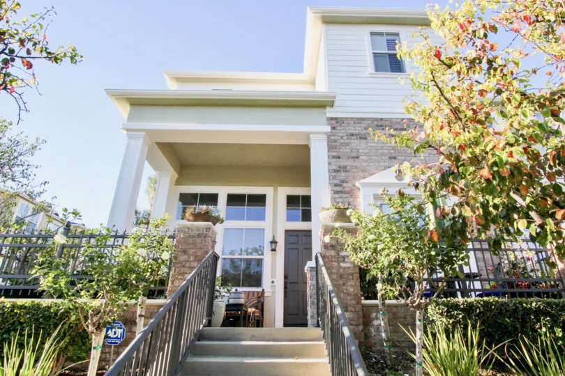 a warm day in the kensington court with a house that has steps in center and garden around