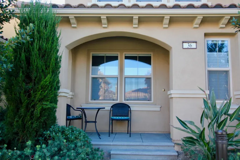 A small patio with two chairs and a table located inside La Casella in irvine CA