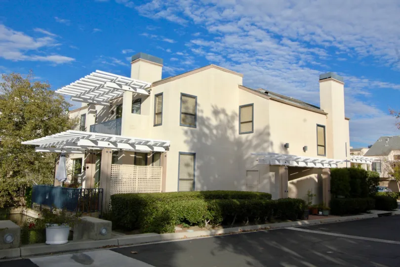 THIS IMAGE SHOWS THE HOUSE WITH PLANTS, TREES, ROADWAY WHICH IS IN IRVINE CITY