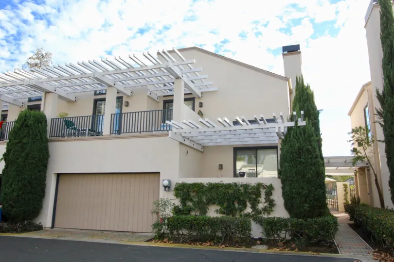 A sunny day in Lakeshore with a large house with a balcony and a garage.