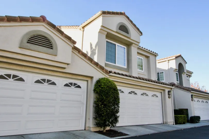A clear day showing the white garages of a home in the Las Palmas community of Irvine California.