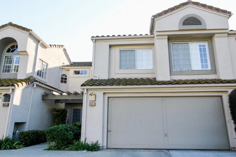 Creamy exterior of a Las Palmas townhome in Irvine, California.