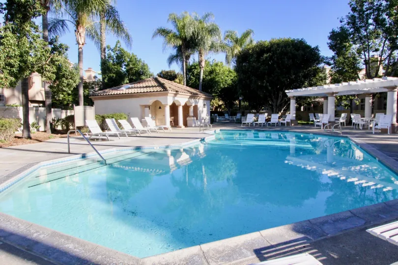 The Las Palmas with a large swimming pool with chairs arranged beside.