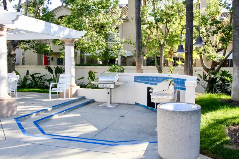 A Villa in Las Palmas has wash basin and seating chair back of trees and grass