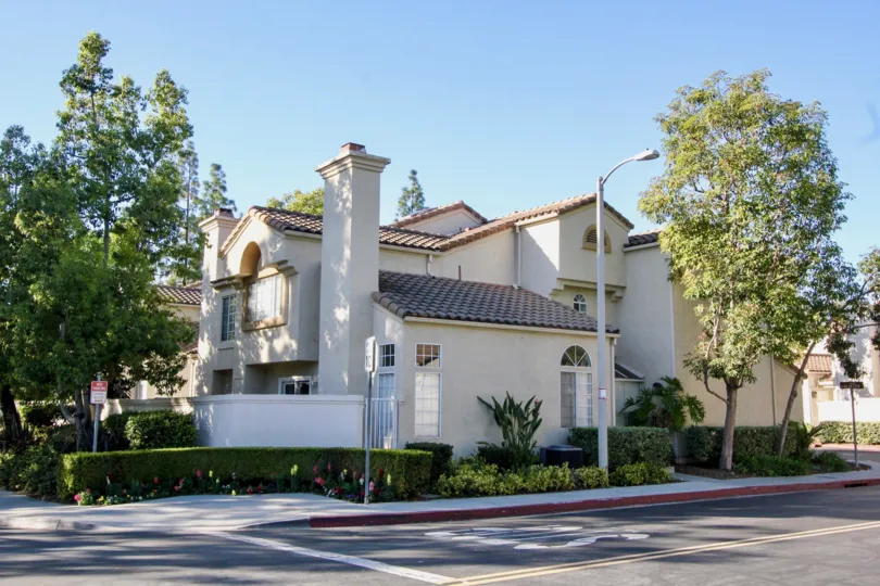 THIS IS THE SIDEVIEW OF THE HOUSE NEARBY ROADWAY, PLANTS, TREES ARE THERE IS IN IRVINE CITY