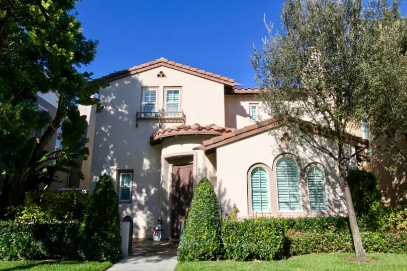 A street view of a home and landscaped yard on a sunny day at Lauerel Quail Hill