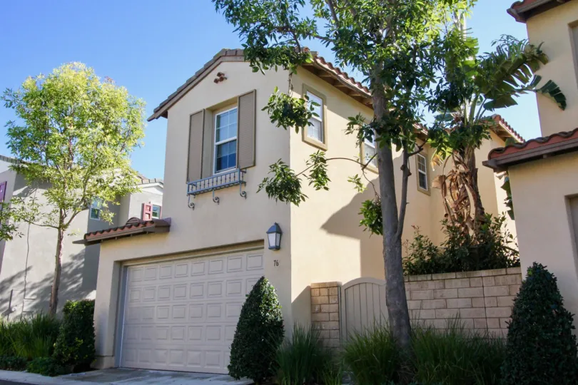 THE FRONTVIEW OF THE HOME WITH SHED, NEARBY PLANTS, TREES, GLASS WINDOWS, LAMP ARE THERE WHICH IS IN IRVINE CITY