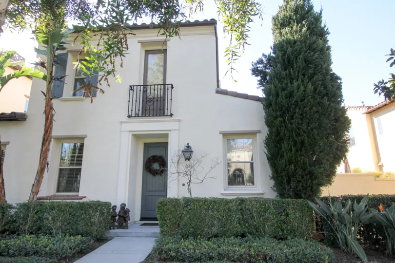 THE FRONT VIEW OF THE VILLA WITH LOT OF PLANTS TREES ARE IN THE IRVINE CITY
