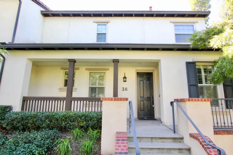 a pleasant day in the lombard court with a house that has numbered as 36 and steps in center and roofless top