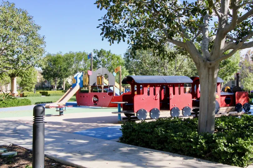 Children's park in Los Arboles has slider, trains with trees