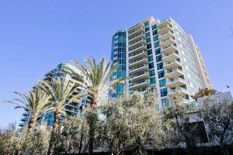 A skyscraper apartment complex with trees out front