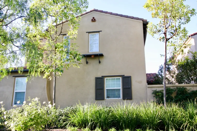 THE BACKSIDE OF THE HOME WITH PLANTS, TREES WHICH IS IN MERICORT COMMUNITY