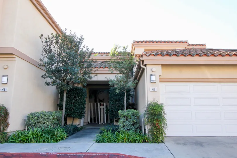 Two sides to the entrance of villa in Northwood Villas has plants and bushes
